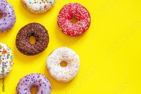 Fototapeta assorted donuts on a yellow background