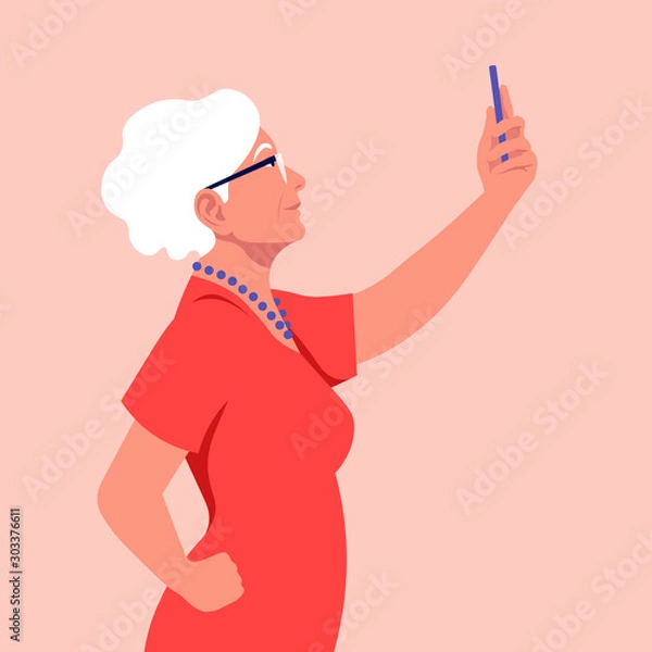 Obraz An old woman takes a selfie and holds her smartphone in her hand. A grandmother is photographed for a social network. Vector flat illustration