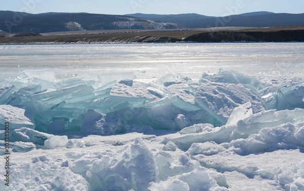 Obraz Blue ice of Lake Baikal covered with cracks and hummocks, Russia. The Eastern Siberia.