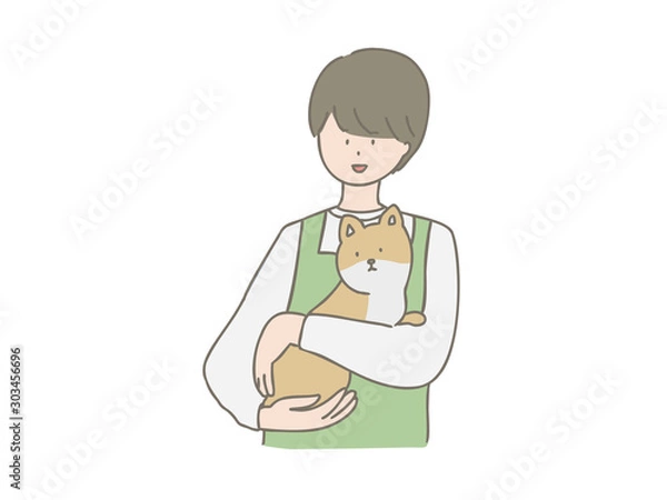 Obraz 子犬を抱っこするペットショップの店員さん