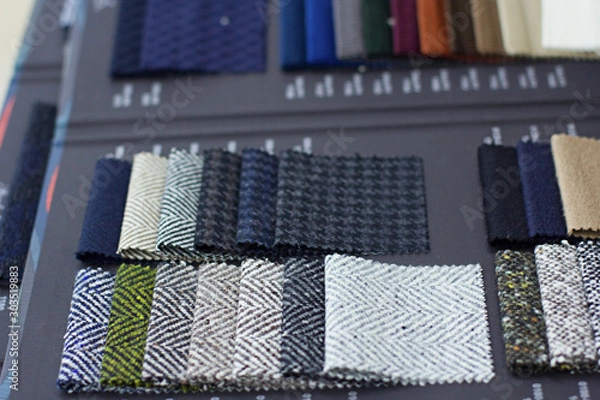 Fototapeta Fabric samples in the tailor shop and tailored suits. Concept of: tailoring, businessman, elegance.