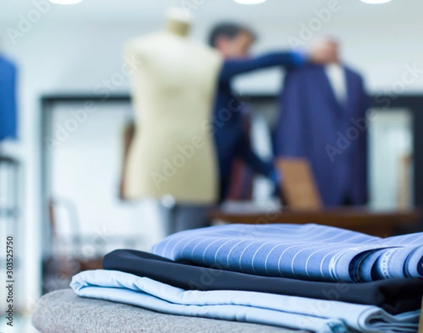 Fototapeta Mannequins in jacket in tailor shop and tailored suits. Concept of: tailoring, businessman, elegance.