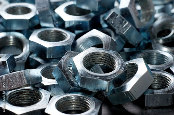 Fototapeta Side view close-up chrome metal nuts