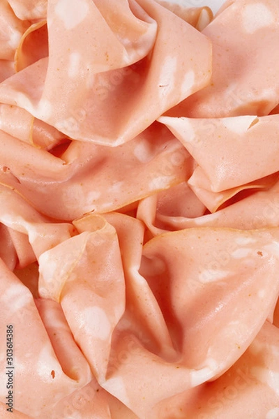 Fototapeta thin slices of mortadella ham isolated on white