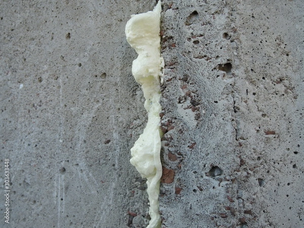 Obraz polyurethane foam filled crack in the wall