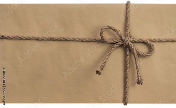Obraz Schleife aus dickem Kordelband auf Packpapier