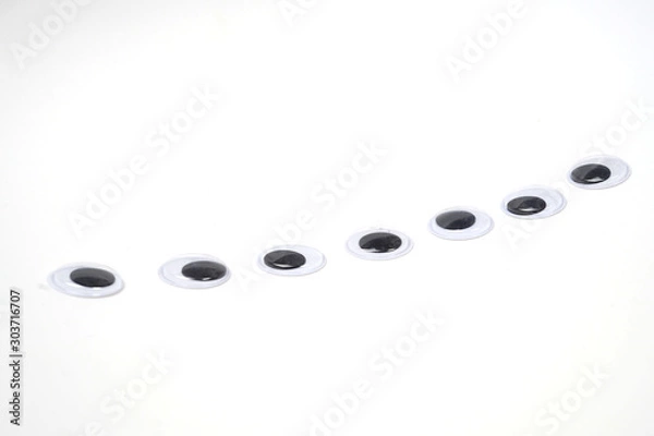 Obraz Pile of googly eyes sticker in a row - isolated white background