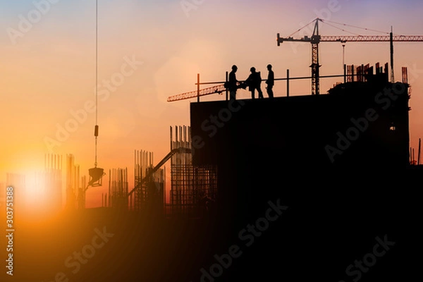 Fototapeta Silhouette of engineer and construction team working at site over blurred background for industry background with Light fair.Create from multiple reference images together