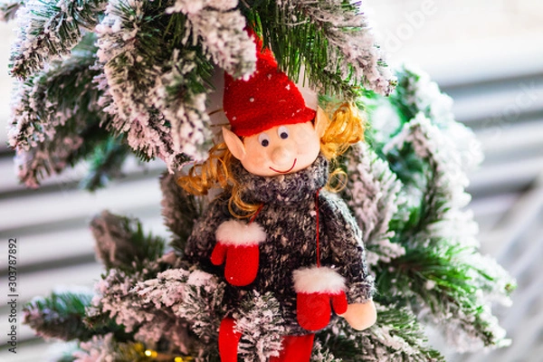 Fototapeta Handmade funny christmas elf toy on the tree