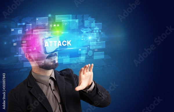 Fototapeta Businessman looking through Virtual Reality glasses with ATTACK inscription, innovative security concept