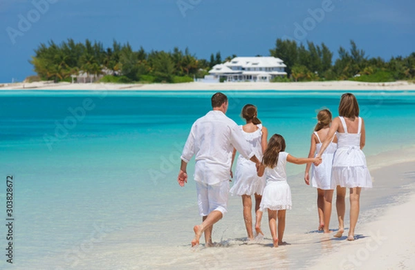 Fototapeta Happy Caucasian family in white walking on beach