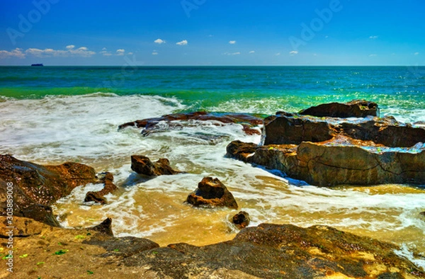 Fototapeta Beautiful landscape with rocks and sea waves on a sunny beach
