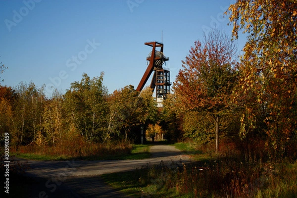 Obraz mining tower behind autumn trees
