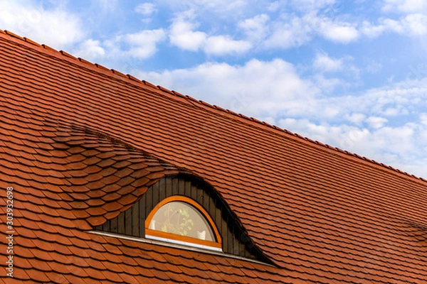 Obraz red tile roof with window and blue sky