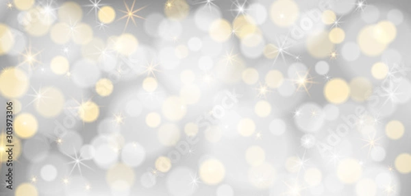 Fototapeta Silver bokeh background. Christmas glowing silver and golden lights with sparkles. Holiday decorative effect.