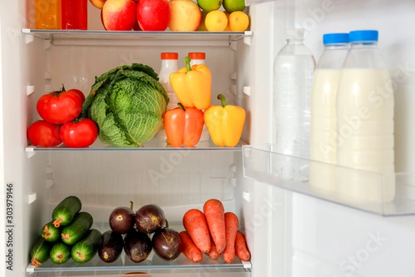 Obraz Different products on shelves in fridge