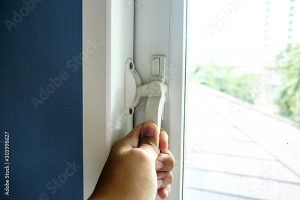 Fototapeta Unlocking the windows for fresh air