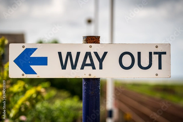 Obraz Sign: Way Out, with blurry background, seen in Kirkby-in-Furness, Cumbria, England, UK
