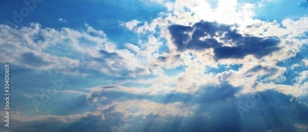 Obraz Sun breaking through clowds blue