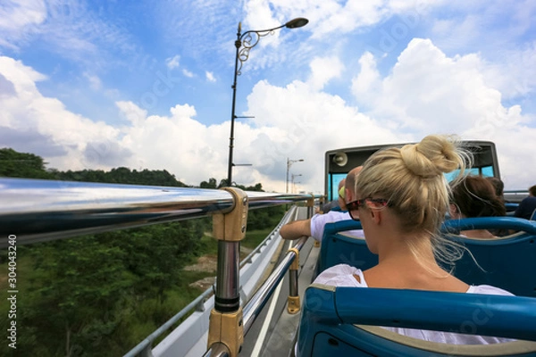 Obraz Open bus top view of tourist activity on double decker bus and motion blur