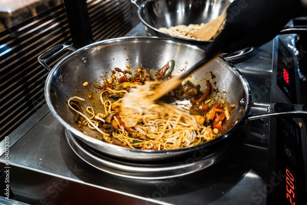 Obraz chef cooking noodles in the restaurant