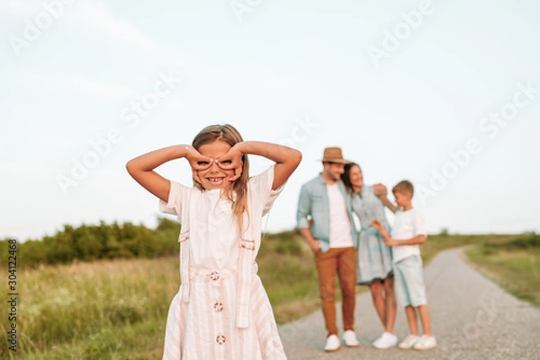 Fototapeta Happy smiling family spending summer day at park.