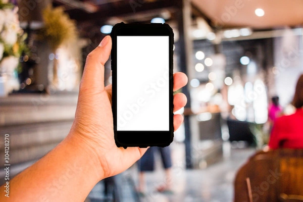 Fototapeta Close up of Hand man holding smart phone in office blurred background