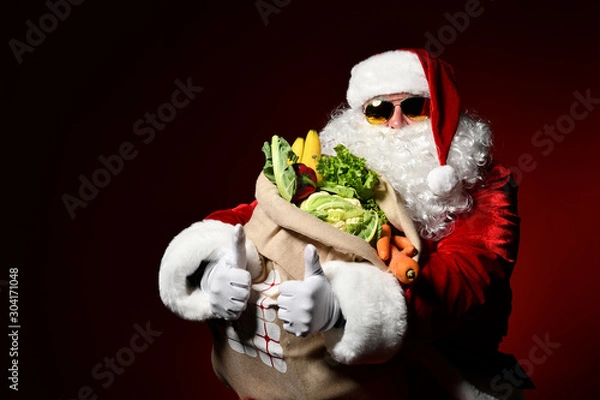 Fototapeta Santa Claus with a bag full of vegetables and fruits