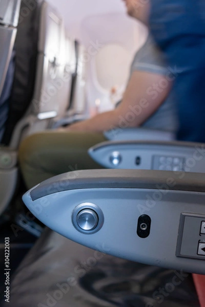 Fototapeta Close Up of Armrest inside an Airplane during Flight