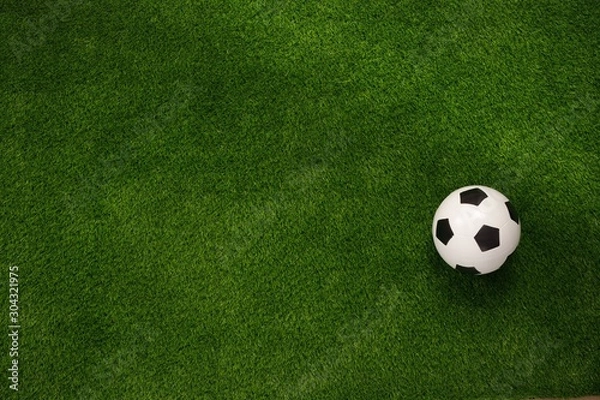 Fototapeta Soccer ball on the green field. View from above. flat lay.Copy space.