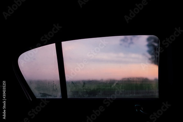 Obraz Sunset in a frame of a car backseat window