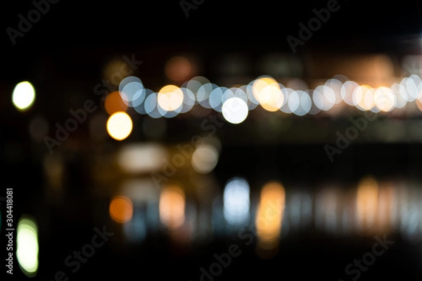 Fototapeta Colorful bokeh light, reflecting in the water of a harbor