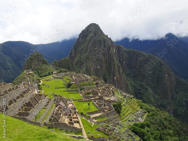 Fototapeta A spectacular view of the ancient Inca town of Machu Picchu with Huayna Picchu Mountain in the background, Ruins of Inca Empire city, Peru