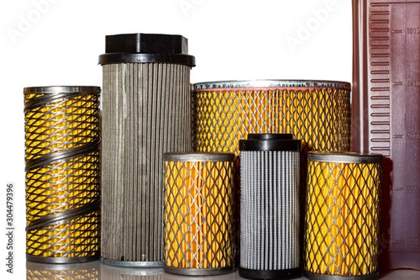 Obraz A lot of different paper and metal filters with a bottle of oil on a white background.