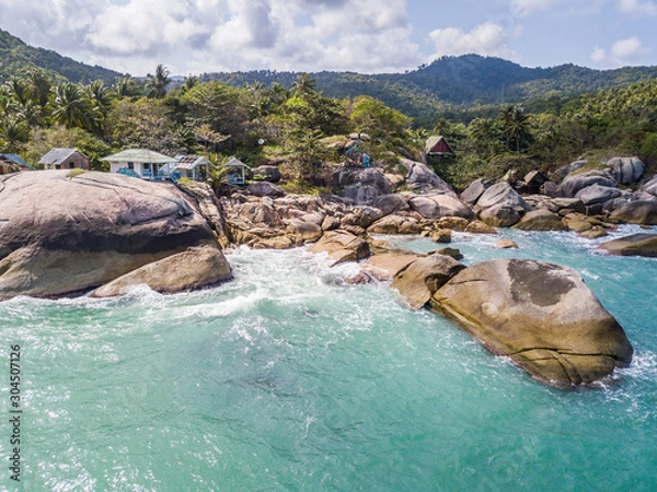 Obraz Aerial view of turquoise waves beating on stones. Thailand