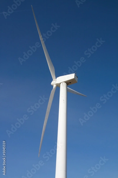Fototapeta windmill on blue sky from the side