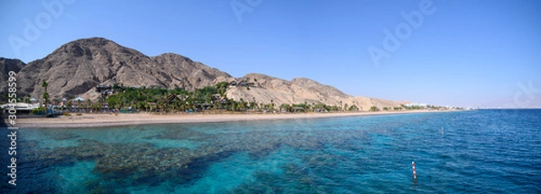 Obraz View on coral reef and resort hotels at southern beach of Eilat city aerial view shot from the sea