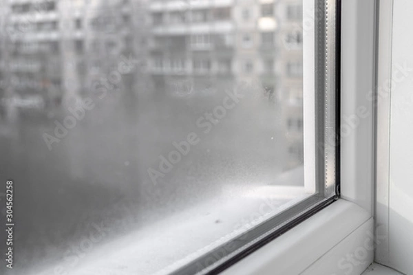 Obraz Water condensation on PVC windows during autumn. Plastic window.