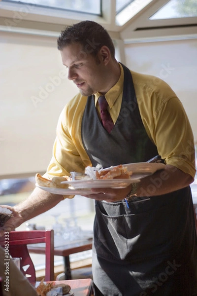 Fototapeta Waiter cleaning table