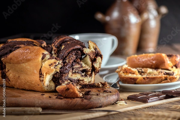 Obraz Swirl cake with chocolate on wooden background
