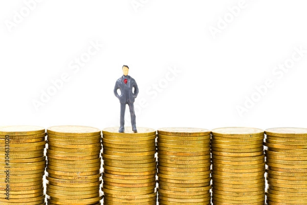 Fototapeta Figure miniature businessman or small people standing on the top stack of coin on white background for money and financial business concept.