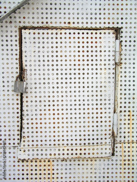Obraz perforated white iron door locked