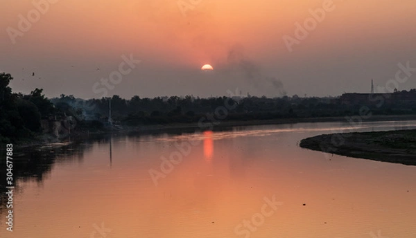 Obraz Sunset on a river in India