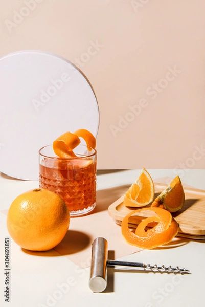 Fototapeta Summer cocktail with orange and lemon slices. Plug puller besides. Abstract studio conception.