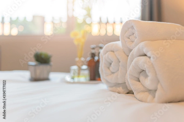 Obraz White towel on bed in guest room for hotel customer. Towels  in spa or fitness center.