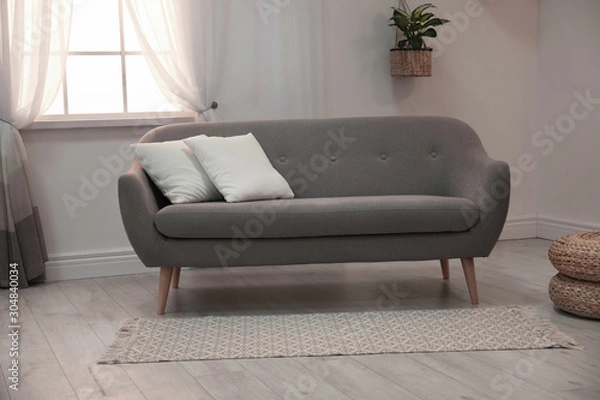 Fototapeta Modern comfortable sofa in stylish home interior