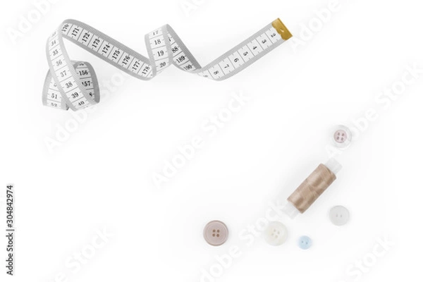 Fototapeta Set from sewing Accessories (a centimetric measuring tape, a set of buttons, color threads) with empty space for text isolated on the white background.
