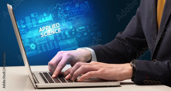 Fototapeta Businessman working on laptop with APPLIED SCIENCE inscription, cyber technology concept