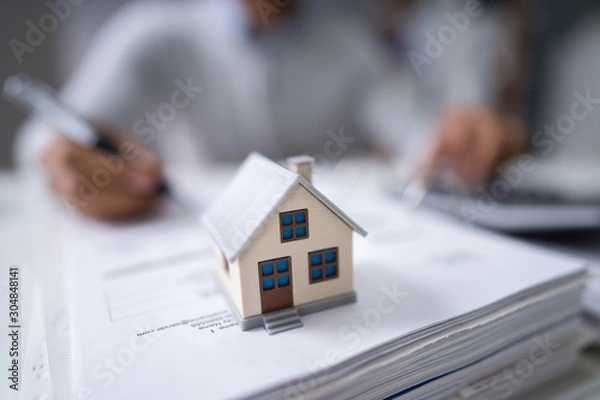 Fototapeta Businessman's Hand Calculating Invoice
