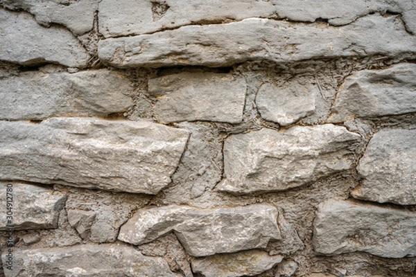 Fototapeta Background of an old wall of stone and clay with straw